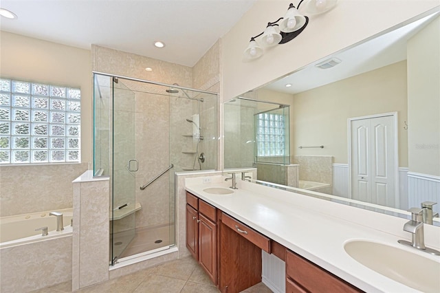 12644 20th St E, Parrish, FL 34219 - full bath featuring double vanity, a bath, tile patterned flooring, a shower stall, and healthy amount of natural light
