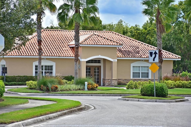 12644 20th St E, Parrish, FL 34219 - view of front of home featuring stucco siding, a tile roof, french doors, and stone siding