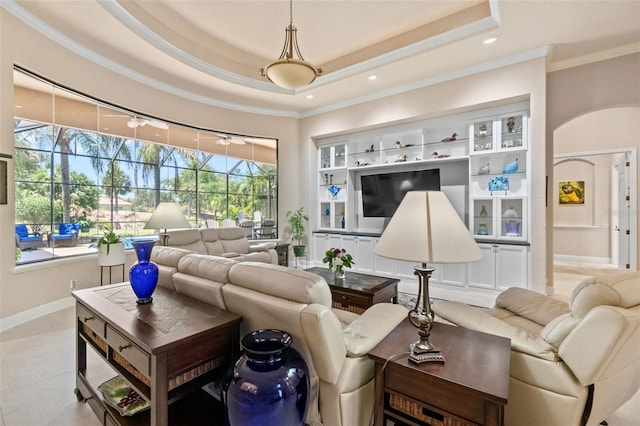 6808 Belmont Ct, Lakewood Ranch, FL 34202 - living room with ornamental molding, recessed lighting, baseboards, a tray ceiling, and built in features