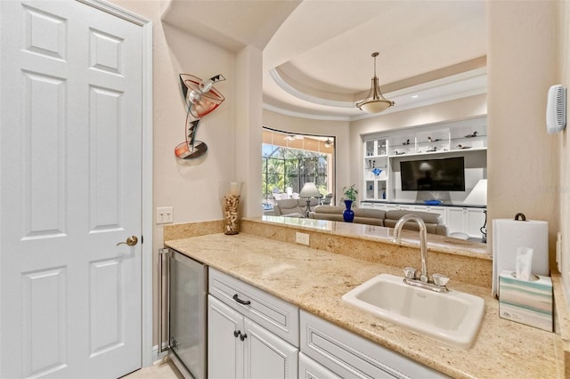6808 Belmont Ct, Lakewood Ranch, FL 34202 - kitchen featuring wine cooler, a sink, open floor plan, white cabinets, and hanging light fixtures