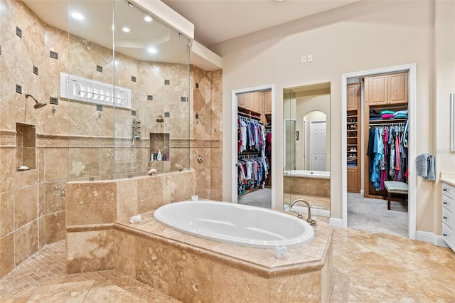 6808 Belmont Ct, Lakewood Ranch, FL 34202 - full bath featuring a garden tub, tiled shower, a walk in closet, and recessed lighting