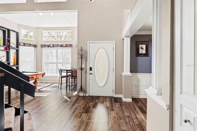 2306 63rd St W Unit 40, Bradenton, FL 34209 - entrance foyer featuring dark wood finished floors, decorative columns, and baseboards