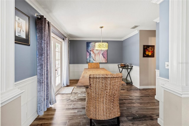 2306 63rd St W Unit 40, Bradenton, FL 34209 - dining space with wainscoting, a decorative wall, and dark wood finished floors