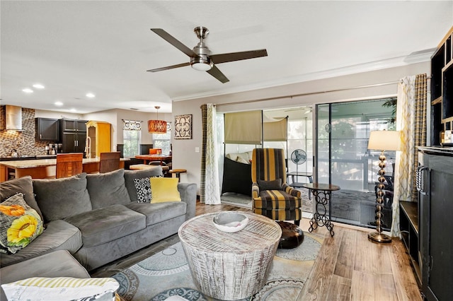 2306 63rd St W Unit 40, Bradenton, FL 34209 - living area with crown molding, light wood-type flooring, a ceiling fan, and recessed lighting