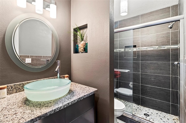 2306 63rd St W Unit 40, Bradenton, FL 34209 - full bath featuring toilet, a stall shower, vanity, and a textured wall