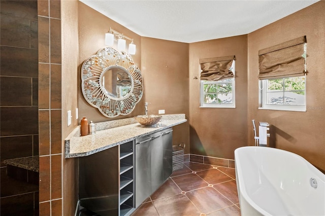 2306 63rd St W Unit 40, Bradenton, FL 34209 - full bath featuring a freestanding bath, tile patterned floors, vanity, and baseboards