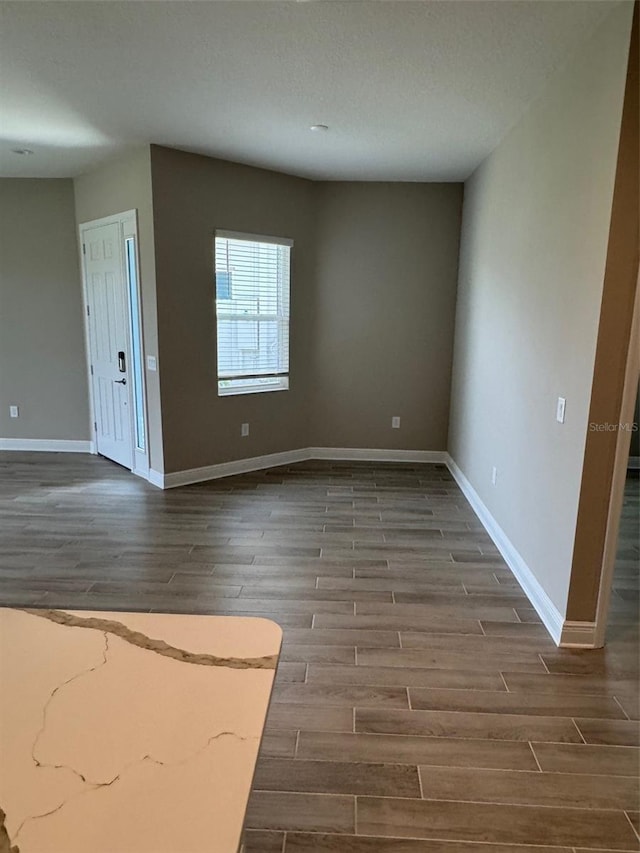 24831 Buckingham Way, Port Charlotte, FL 33980 - unfurnished room featuring dark wood-style flooring and baseboards