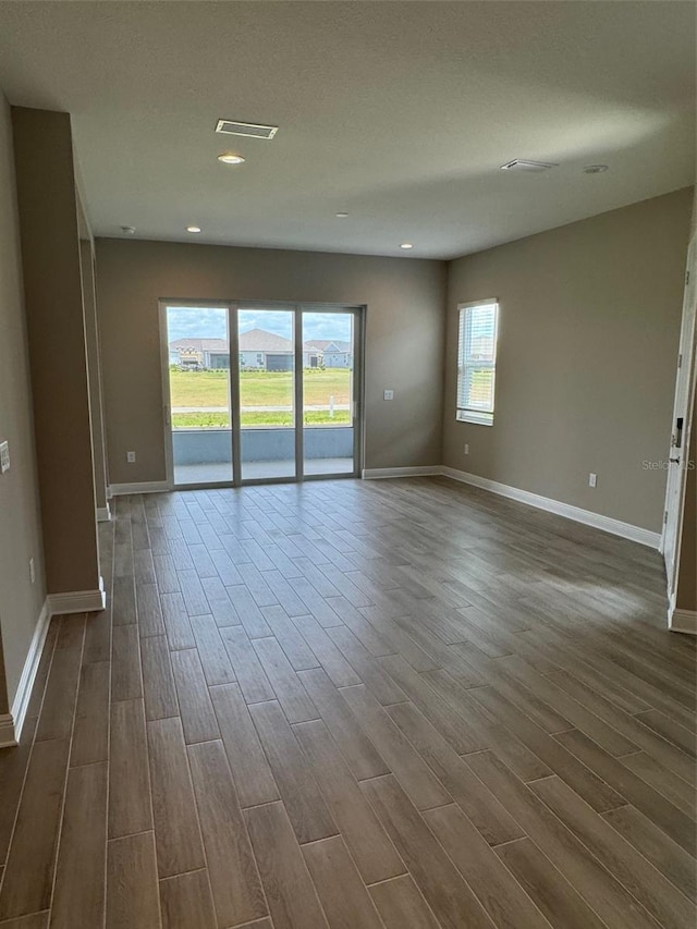 24831 Buckingham Way, Port Charlotte, FL 33980 - empty room with dark wood finished floors, baseboards, and recessed lighting