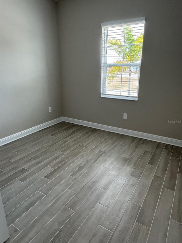 24831 Buckingham Way, Port Charlotte, FL 33980 - unfurnished room with baseboards and dark wood-style flooring