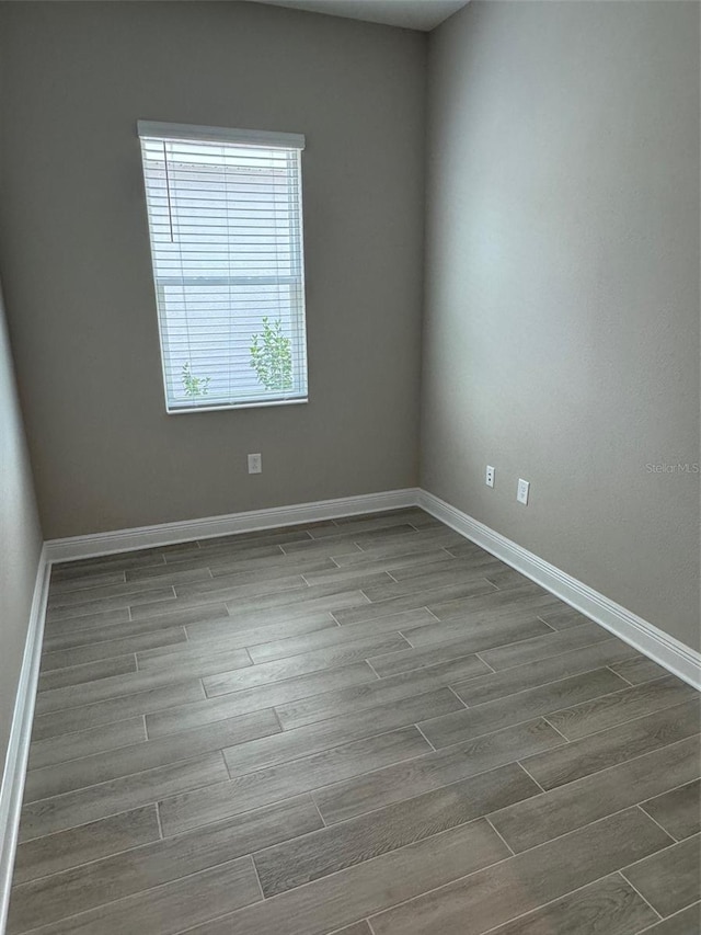 24831 Buckingham Way, Port Charlotte, FL 33980 - empty room with wood finished floors and baseboards