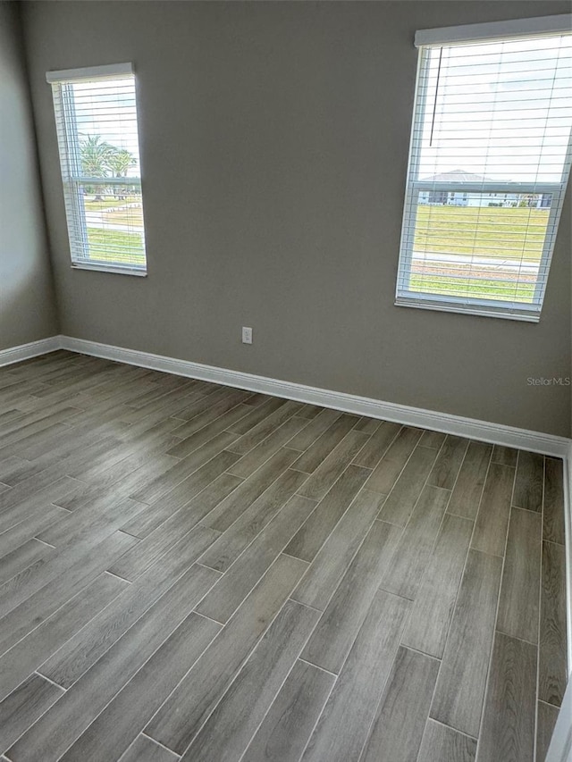24831 Buckingham Way, Port Charlotte, FL 33980 - empty room with dark wood-type flooring and baseboards