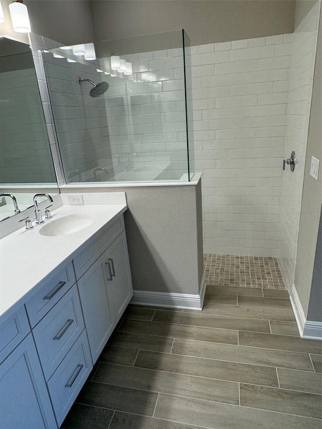 24831 Buckingham Way, Port Charlotte, FL 33980 - full bath featuring wood tiled floors, walk in shower, vanity, and baseboards