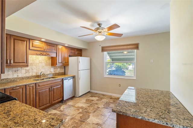 135 Gulfview Rd, Punta Gorda, FL 33950 - kitchen featuring a sink, dishwasher, freestanding refrigerator, backsplash, and baseboards