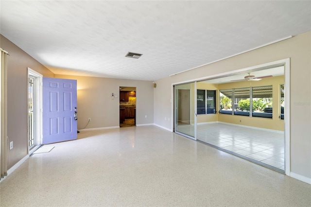 135 Gulfview Rd, Punta Gorda, FL 33950 - unfurnished living room with baseboards, ceiling fan, and speckle patterned floor