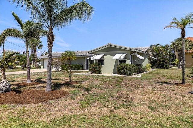 135 Gulfview Rd, Punta Gorda, FL 33950 - view of front of property featuring a garage, stucco siding, a front yard, concrete driveway, and a tile roof