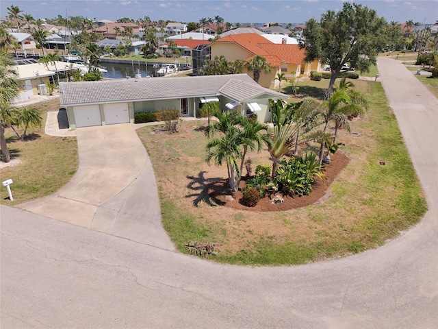135 Gulfview Rd, Punta Gorda, FL 33950 - view of front facade with concrete driveway, an attached garage, stucco siding, a residential view, and a tiled roof