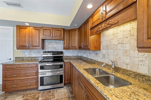 135 Gulfview Rd, Punta Gorda, FL 33950 - kitchen with double oven range, a sink, brown cabinetry, tasteful backsplash, and recessed lighting