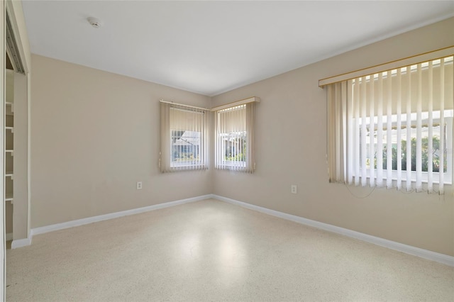 135 Gulfview Rd, Punta Gorda, FL 33950 - empty room featuring healthy amount of natural light, baseboards, and speckle patterned floor