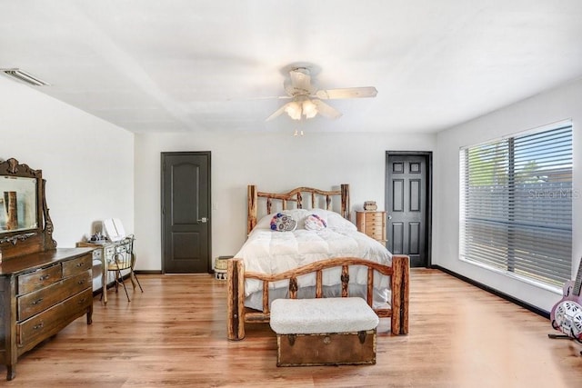 7321 Caladesia Dr, Sarasota, FL 34243 - bedroom with light wood-style flooring, baseboards, and ceiling fan