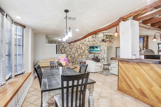7321 Caladesia Dr, Sarasota, FL 34243 - dining room featuring tile patterned floors and a stone fireplace