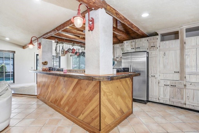 7321 Caladesia Dr, Sarasota, FL 34243 - kitchen featuring stainless steel refrigerator with ice dispenser, plenty of natural light, light tile patterned floors, vaulted ceiling, and recessed lighting