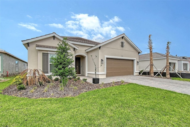 11427 Viani Ter, Palmetto, FL 34221 - single story home featuring stucco siding, decorative driveway, a garage, and a front lawn