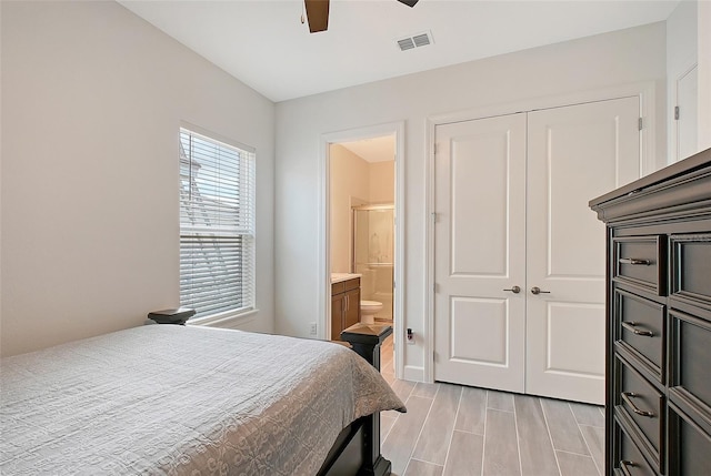 11427 Viani Ter, Palmetto, FL 34221 - bedroom featuring a closet, ensuite bathroom, and a ceiling fan