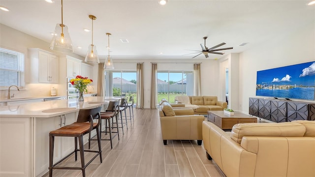 11427 Viani Ter, Palmetto, FL 34221 - living area featuring ceiling fan, recessed lighting, and light wood-style flooring