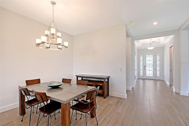11427 Viani Ter, Palmetto, FL 34221 - dining space with baseboards, a chandelier, and wood finished floors