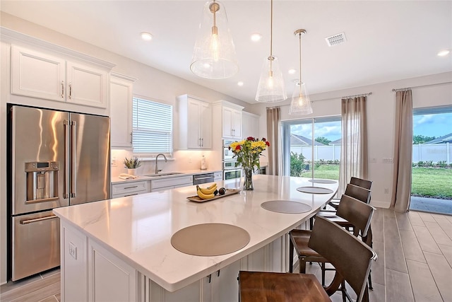 11427 Viani Ter, Palmetto, FL 34221 - kitchen with stainless steel appliances, a sink, plenty of natural light, recessed lighting, and white cabinets
