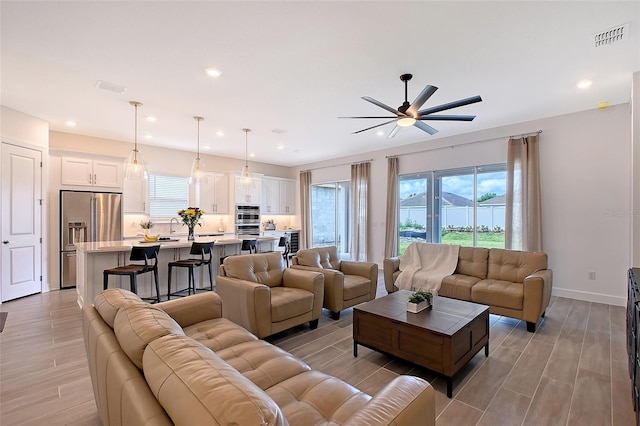 11427 Viani Ter, Palmetto, FL 34221 - living area featuring light wood-style flooring, a ceiling fan, recessed lighting, and baseboards