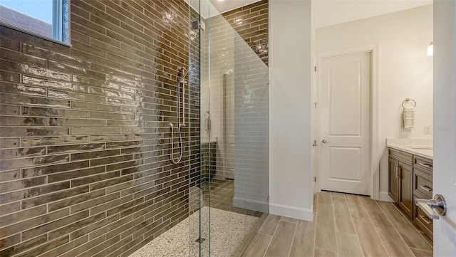 11427 Viani Ter, Palmetto, FL 34221 - bathroom featuring vanity, a shower stall, wood finished floors, and baseboards