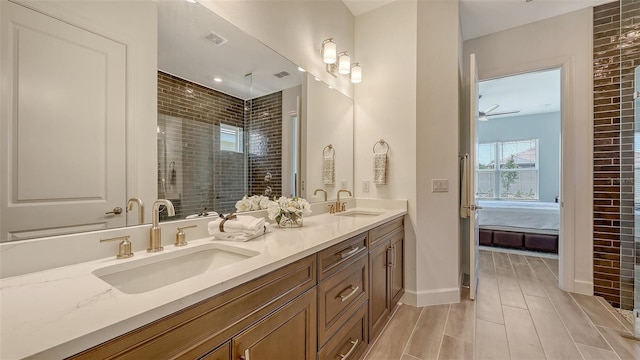 11427 Viani Ter, Palmetto, FL 34221 - bathroom with double vanity, connected bathroom, a stall shower, baseboards, and wood finish floors
