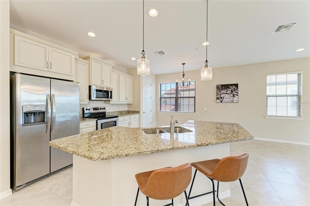 121 Porta Vecchio Bnd Unit 201, Nokomis, FL 34275 - kitchen featuring appliances with stainless steel finishes, a sink, plenty of natural light, light tile patterned floors, and recessed lighting