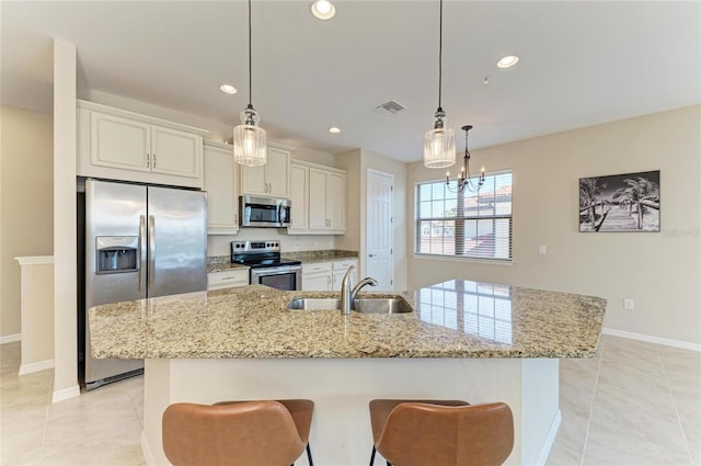 121 Porta Vecchio Bnd Unit 201, Nokomis, FL 34275 - kitchen with stainless steel appliances, a sink, light stone counters, baseboards, and recessed lighting