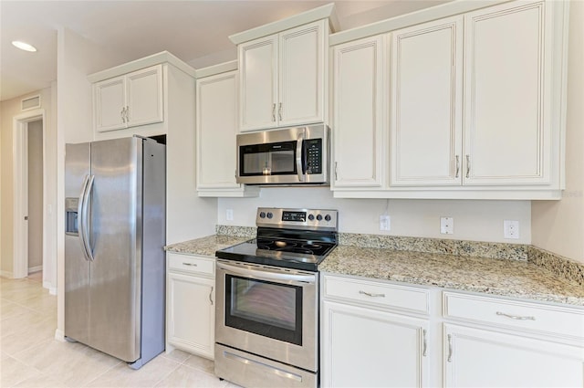 121 Porta Vecchio Bnd Unit 201, Nokomis, FL 34275 - kitchen featuring stainless steel appliances, light tile patterned floors, light stone countertops, and recessed lighting