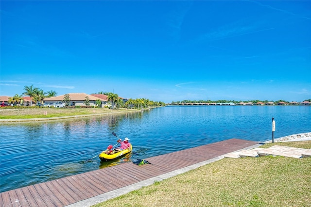 121 Porta Vecchio Bnd Unit 201, Nokomis, FL 34275 - dock area with a water view and a lawn