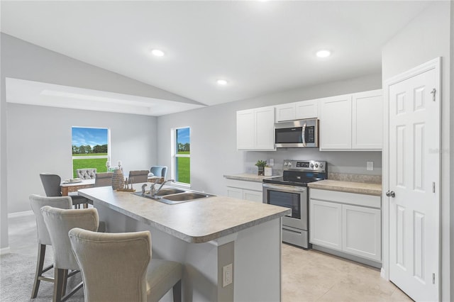 10539 Kidron Ave, Englewood, FL 34224 - kitchen featuring appliances with stainless steel finishes, lofted ceiling, a breakfast bar area, a sink, and recessed lighting