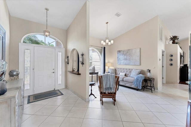 4585 Dover Street Cir E, Bradenton, FL 34203 - foyer featuring a chandelier, high vaulted ceiling, healthy amount of natural light, light tile patterned floors, and baseboards
