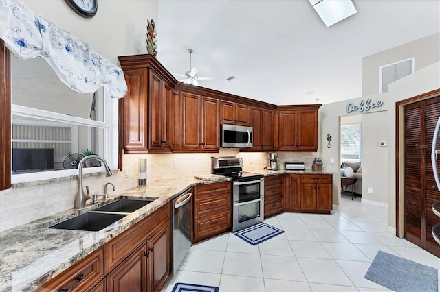 4585 Dover Street Cir E, Bradenton, FL 34203 - kitchen with appliances with stainless steel finishes, a sink, tasteful backsplash, ceiling fan, and light tile patterned flooring