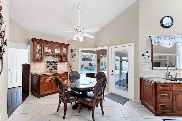 4585 Dover Street Cir E, Bradenton, FL 34203 - dining room with a ceiling fan, light tile patterned floors, high vaulted ceiling, and french doors