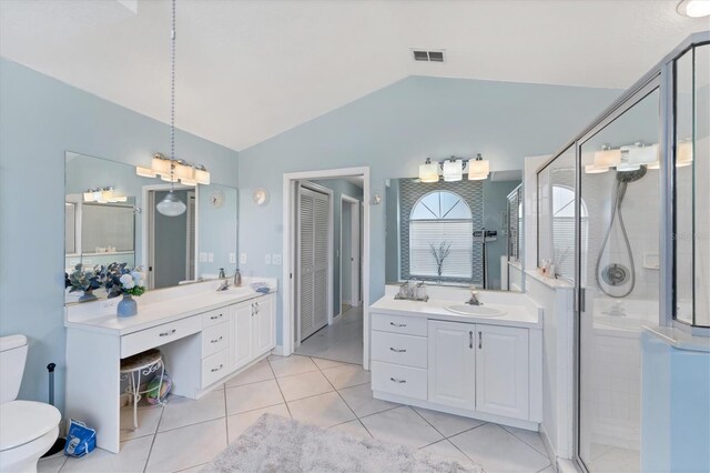 4585 Dover Street Cir E, Bradenton, FL 34203 - full bathroom with vaulted ceiling, toilet, a shower stall, two vanities, and tile patterned flooring