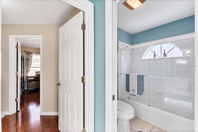 4585 Dover Street Cir E, Bradenton, FL 34203 - full bath featuring combined bath / shower with glass door, toilet, and wood finished floors