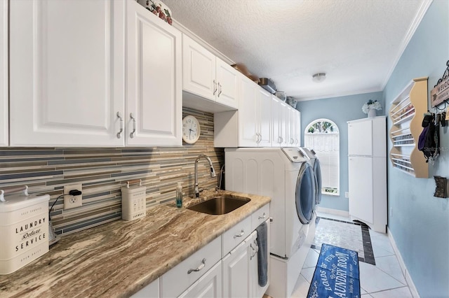 4585 Dover Street Cir E, Bradenton, FL 34203 - laundry room with independent washer and dryer, cabinet space, a textured ceiling, light tile patterned floors, and ornamental molding