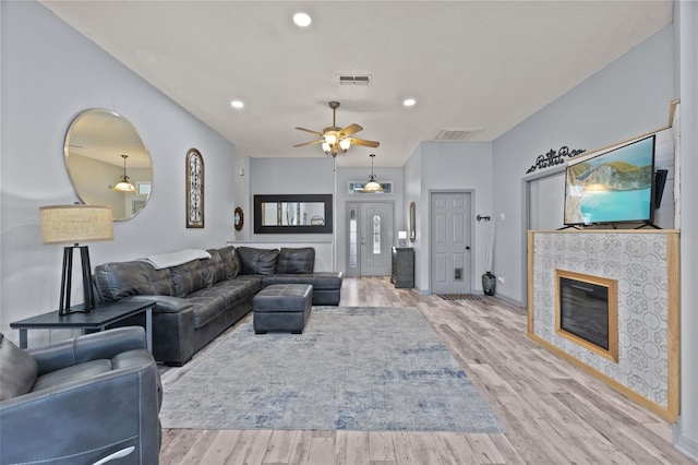 318 39th St NE, Bradenton, FL 34208 - living area featuring ceiling fan, wood finished floors, recessed lighting, and a tiled fireplace
