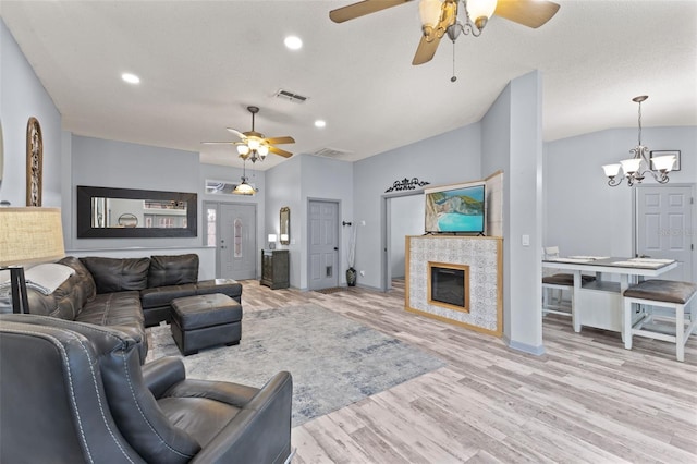318 39th St NE, Bradenton, FL 34208 - living room featuring a ceiling fan, a chandelier, wood finished floors, recessed lighting, and a tiled fireplace