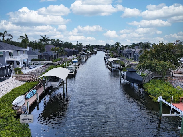 318 39th St NE, Bradenton, FL 34208 - water view featuring boat lift, a boat dock, and nearby suburban area