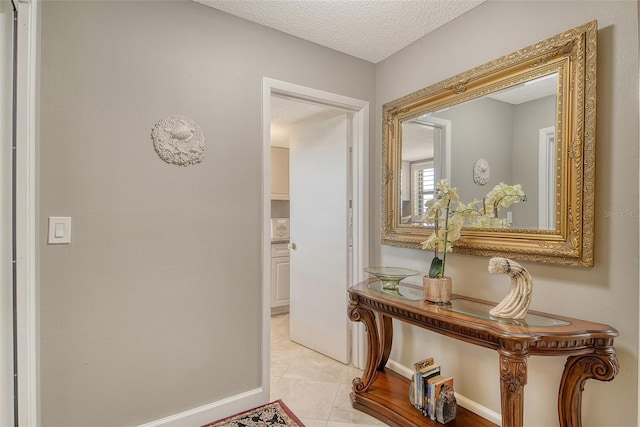 8779 Midnight Pass Rd Unit 506H, Sarasota, FL 34242 - hallway featuring a textured ceiling, baseboards, and light tile patterned flooring