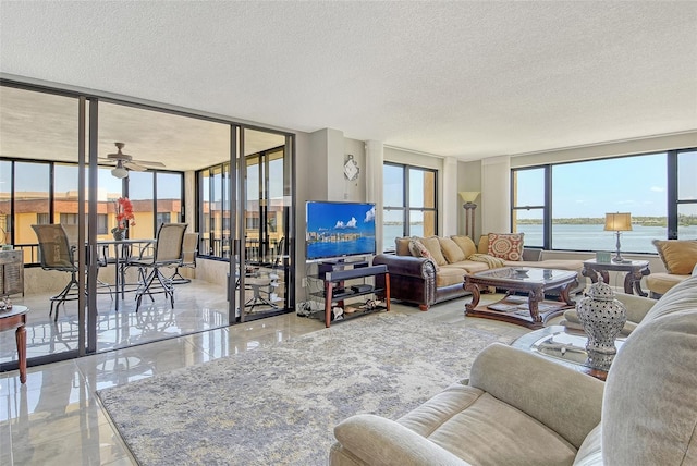 8779 Midnight Pass Rd Unit 506H, Sarasota, FL 34242 - living area featuring a textured ceiling, expansive windows, and ceiling fan