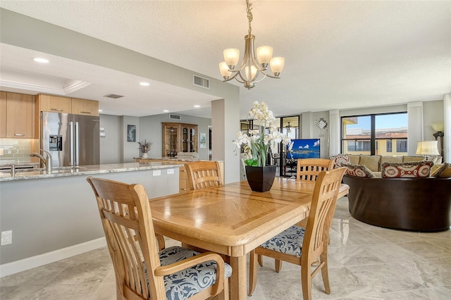 8779 Midnight Pass Rd Unit 506H, Sarasota, FL 34242 - dining space featuring a chandelier, a textured ceiling, and recessed lighting